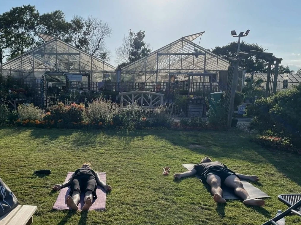 Outdoor garden yoga class smiling participants